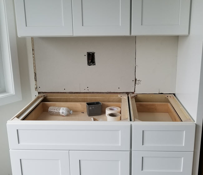 The replacement cabinets are white with shaker style doors.