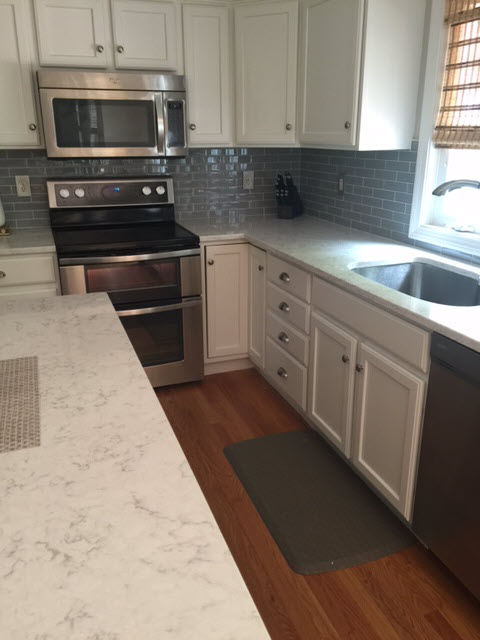 The completed kitchen renovation includes refinished cabinets.