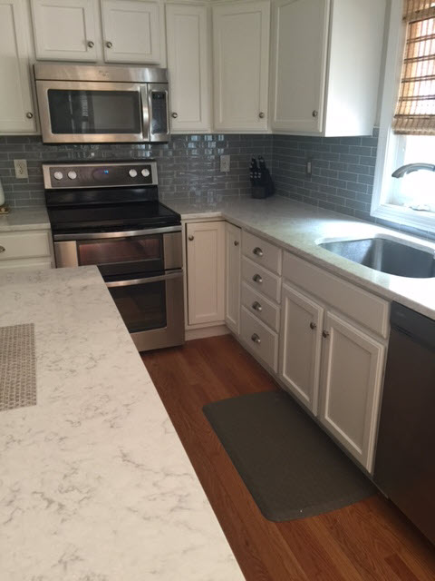 Glossy ceramic subway tile in a grey-blue color in a horizontal layout where the tiles are offset.  