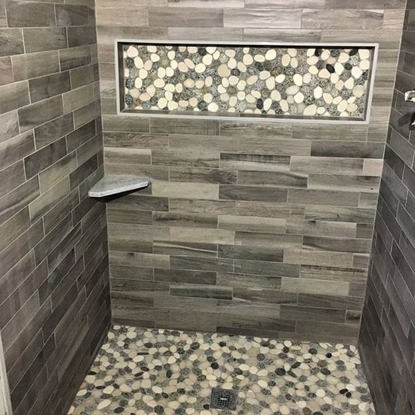 Combine pebbles with porcelain marble tile.