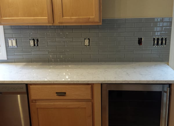 Glass subway tile adds an additional dimension to kitchen backsplashes: it reflects light.