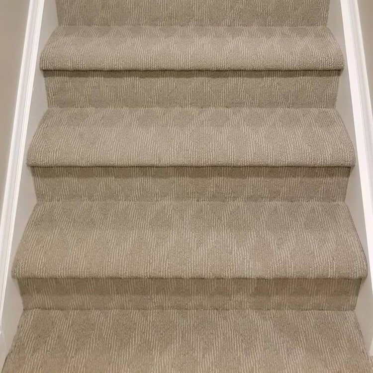 This carpet covers the entire step in a wall-to-wall installation.