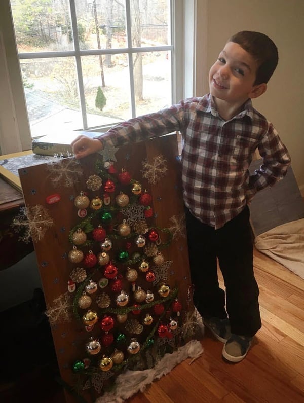 Cole is 5 years old and models his Christmas tree made from ornaments and other fun stuff found at a dollar store