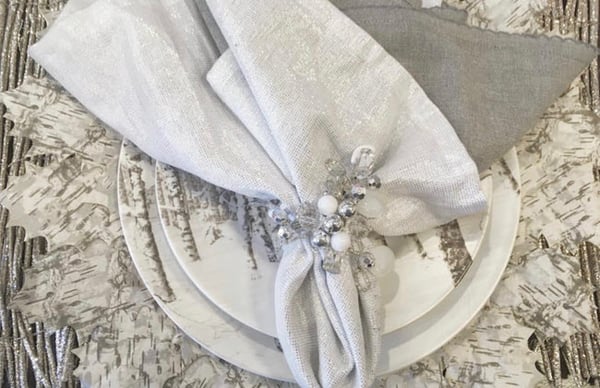 Add birch to the table with placemats and silver linens