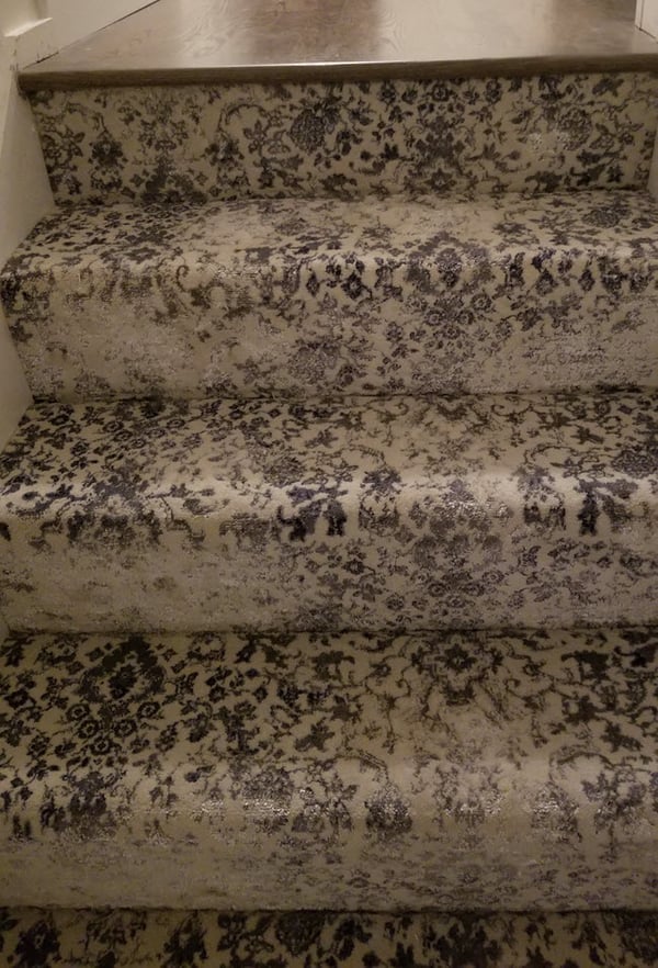 Wall to wall carpeted condo stairs