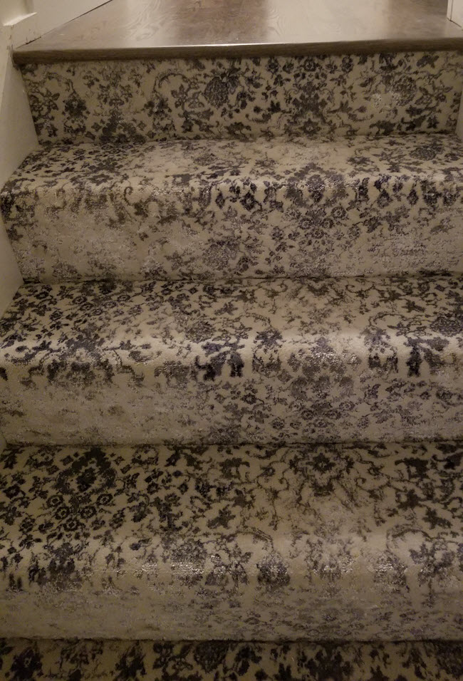 Carpeted stairs installed wall to wall